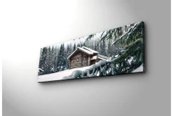 Canvastavla med LED-belysning 30x90 cm - Vinterlandskap med en stuga omgiven av snö och granar