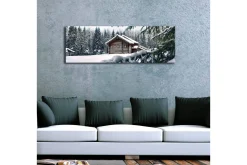 Canvastavla med LED-belysning 30x90 cm - Vinterlandskap med en stuga omgiven av snö och granar