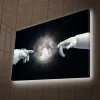 Canvastavla med LED-belysning - Astronauthänder som sträcker sig mot månen