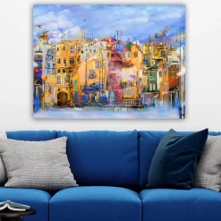 Canvastavla 70x100 cm - Färgglada hus vid en vattenkant i en livlig stadsmiljö