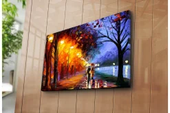 Canvastavla 70x45 cm - Romantisk promenad under regn med paraplyer i en färgglad höstmiljö