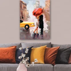 Canvastavla 70x100 cm - Romantisk kyss under ett röd paraply i en stadsmiljö